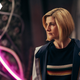 Jodie Whittaker's 13th Doctor glowers in a high-tech control center pulsing with neon pink lighting.